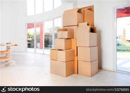 A stack of moving boxes in a new house, ready to unpack