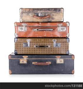 A stack of old suitcases isolated on white background. A stack of old suitcases