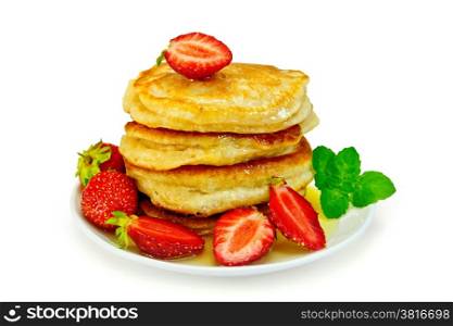 A stack of pancakes with strawberries and honey on a white plate isolated on white background