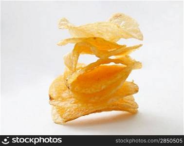 A stack of potato chips on white