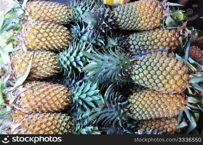 A stack of ripe pineapple fruits