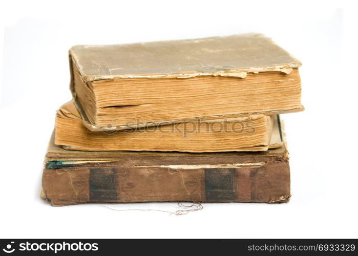 A stack of shabby old books on a white background