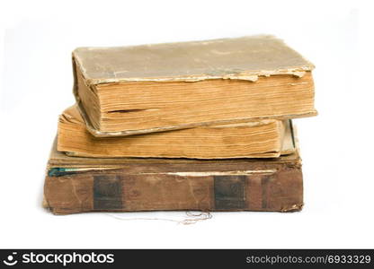 A stack of shabby old books on a white background