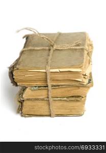 a stack of shabby old books tied with string on white background