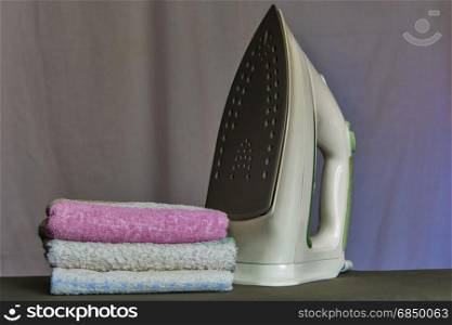 A stack of towels is about iron