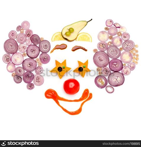 A star-eyed clown made of vegetables.