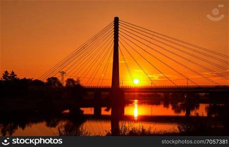 a steel cable bridge over the river Elbe near Radebeul near the Saxon city of Dresden at sunrise. Steel cable bridge at sunrise