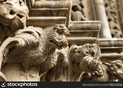 A steries of dragon gargoyles carved in stone line the main entrance door to St. Giles Cathedral in Edinburgh, Scotland.