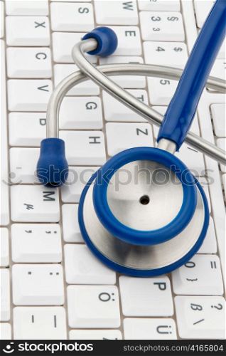 a stethoscope is on the keyboard of a computer. allocation and organization of doctors.
