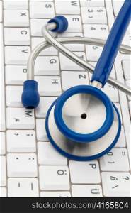 a stethoscope is on the keyboard of a computer. allocation and organization of doctors.