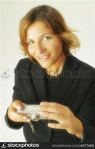 A stock photo of a business woman using a digital camera