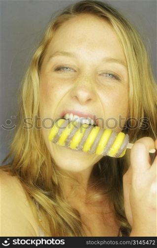 A stock photo of a woman eating food and loving it.