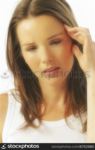 A stock photo of a woman enduring a headache