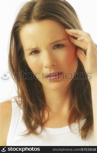 A stock photo of a woman enduring a headache