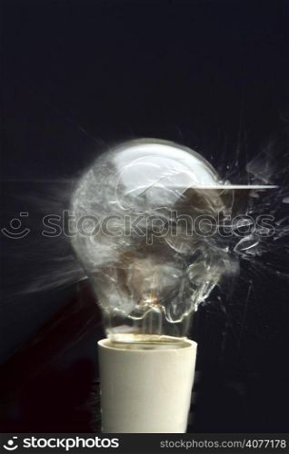 A stock photo of an incandescent light globe explodes. It is smashed by a hammer and captured by a sound activated switch, Speed of sound, speed of light,