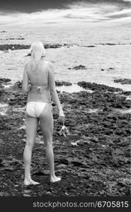 A stock photograph of a beautiful blonde model by the beach.