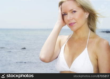 A stock photograph of a beautiful blonde model by the beach.