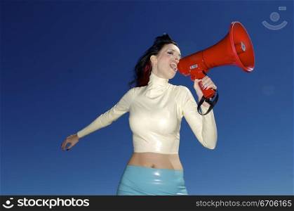A stock photograph of a beautiful woman yelling into a mega phone.