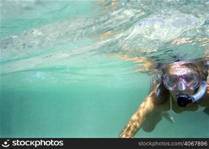 A stock photograph of a beautiful young woman going snorkeling.