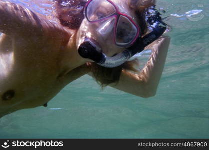 A stock photograph of a beautiful young woman going snorkeling.