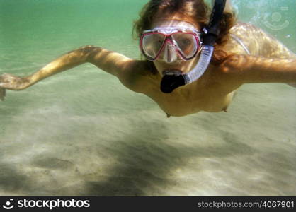 A stock photograph of a beautiful young woman going snorkeling.