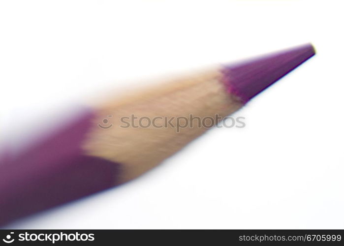 A stock photograph of a color pencil photographed in a close up, focussing on the sharpened tip.