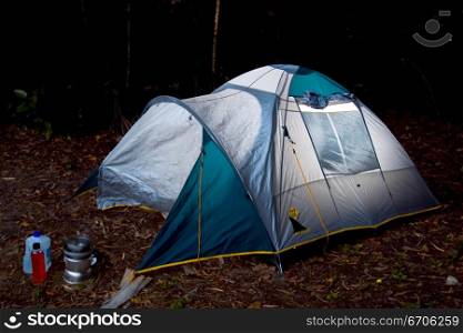 A stock photograph of a tent in a camping ground.
