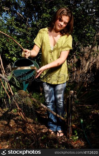 A stock photograph of a young girls adventure in the garden learning how to grow her own food.
