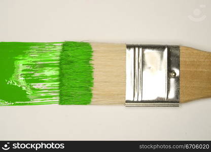 A stock photograph of an artists paint brush with fresh colorful paint on its bristles.