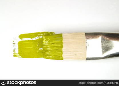 A stock photograph of an artists paint brush with fresh colorful paint on its bristles.