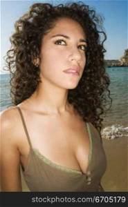 A stock photograph of an attractive young woman with curly hair and dark eyes.