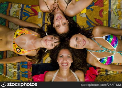 A stock photograph of four gorgeous young girls relaxing by the ocean during a hot summers day in Malta in their bikinis.