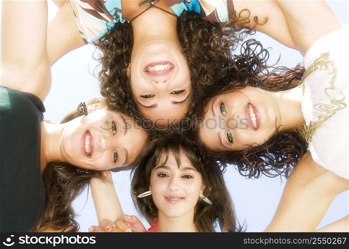 A stock photograph of four gorgeous young girls relaxing by the ocean during a hot summers day in Malta in their bikinis.