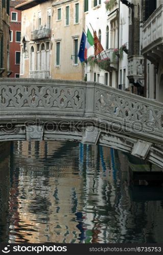 A stone bridge over a canal, Venice, Italy