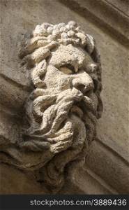 A stone carving of a man with flowing beard that has been applied to the facade of a building in Aix en Provence in Southern France.
