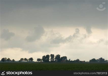 A storm brewing over the polders in Zeeland, the Netherlands, with a dark cloud overhead