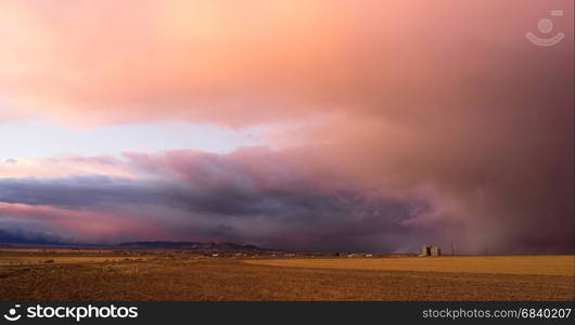 A storm moves in over Milford Utah at sunset making for dramtic skies