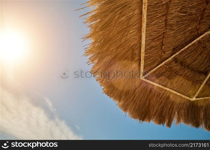 A straw umbrella on a beautiful beach.. A straw umbrella on a beautiful beach