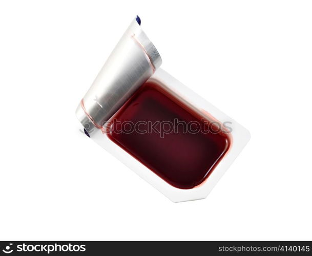 a strawberry jelly in a smal container on white background