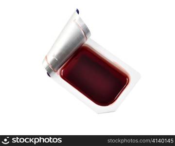 a strawberry jelly in a smal container on white background