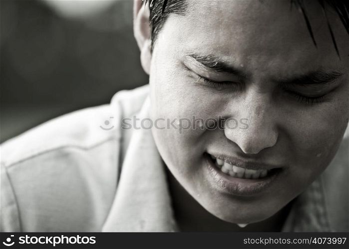A stressed and depressed young asian male in black and white