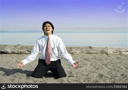A stressed and frustrated businessman screaming on the beach