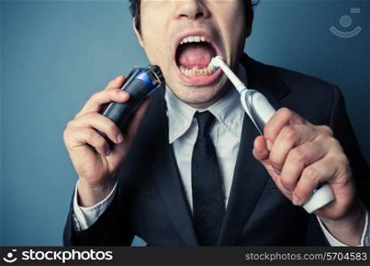 A stressed businessman is late and is shaving and brushing his teeth at the same time