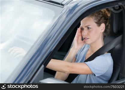 a stressed female driver stuck in traffic jam
