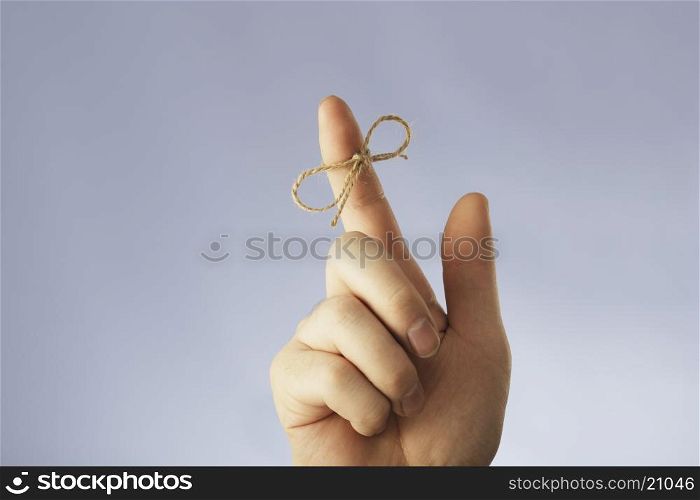 A string tied around an index finger