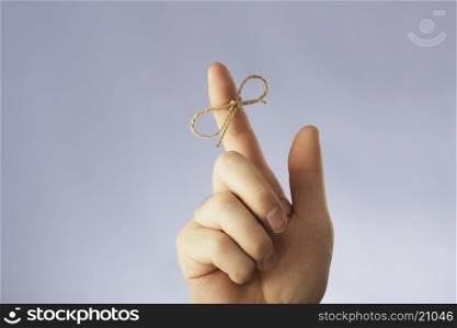 A string tied around an index finger
