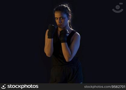 A STRONG FEMALE WRESTLER PRACTICING MOVES IN FRONT OF CAMERA