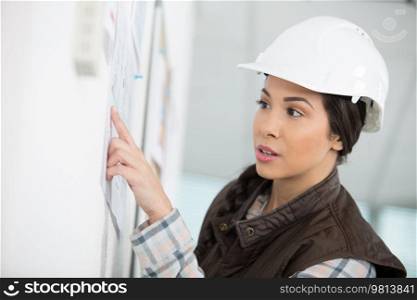a strong-willed woman in a construction helmet