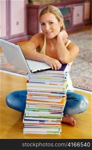 a student sits in front of a stack of books to learn the