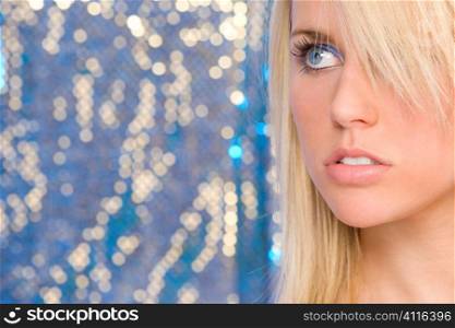 A stunningly beautiful young blonde woman shot against an electric blue background